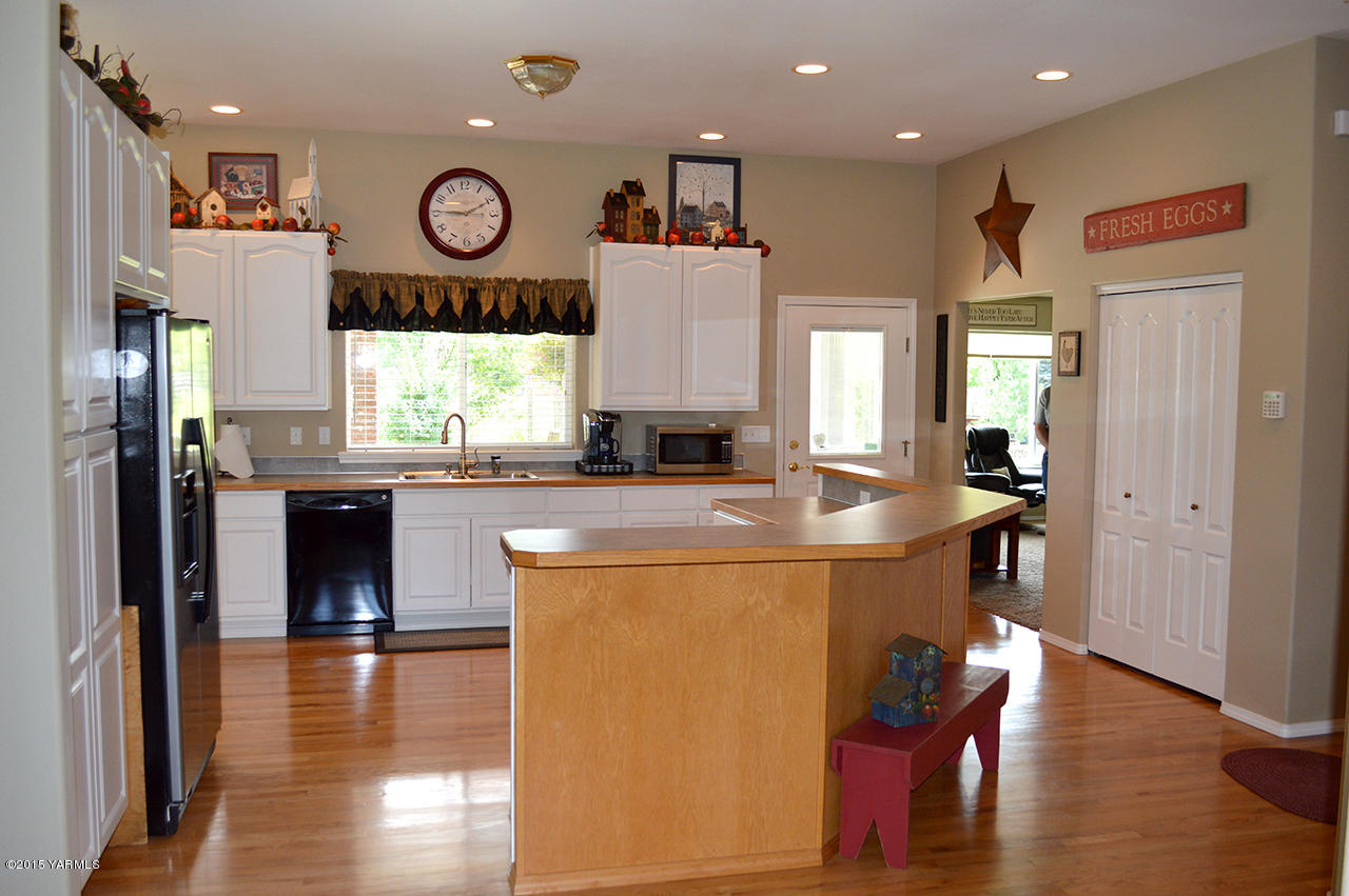 8104 Rutherford Road Yakima, WA 98903 - Photo 6 of 42 a view of a kitchen with granite countertop a stove and a refrigerator