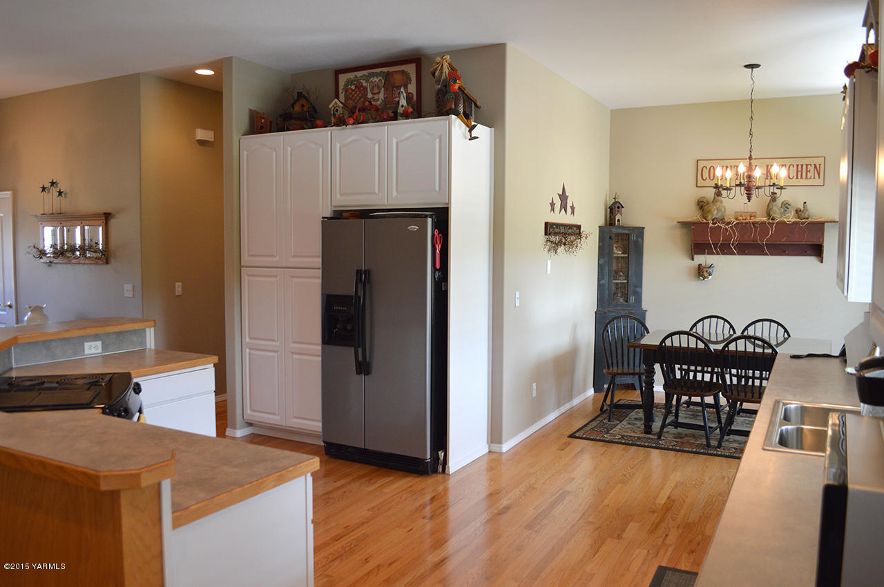 8104 Rutherford Road Yakima, WA 98903 - Photo 10 of 42 a kitchen with granite countertop a refrigerator and a stove top oven