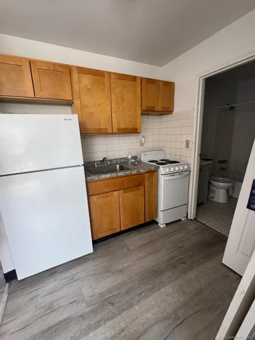 a kitchen with stainless steel appliances a refrigerator sink and cabinets