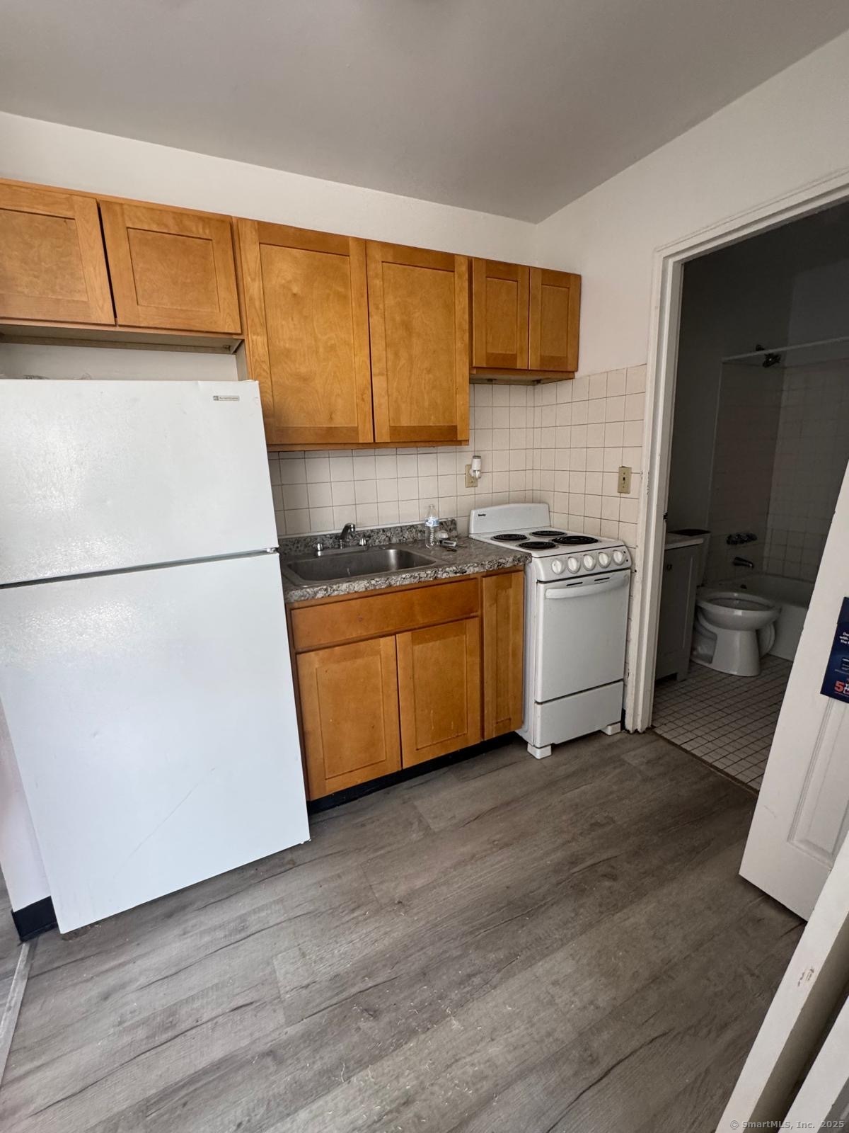 a kitchen with stainless steel appliances a refrigerator sink and cabinets