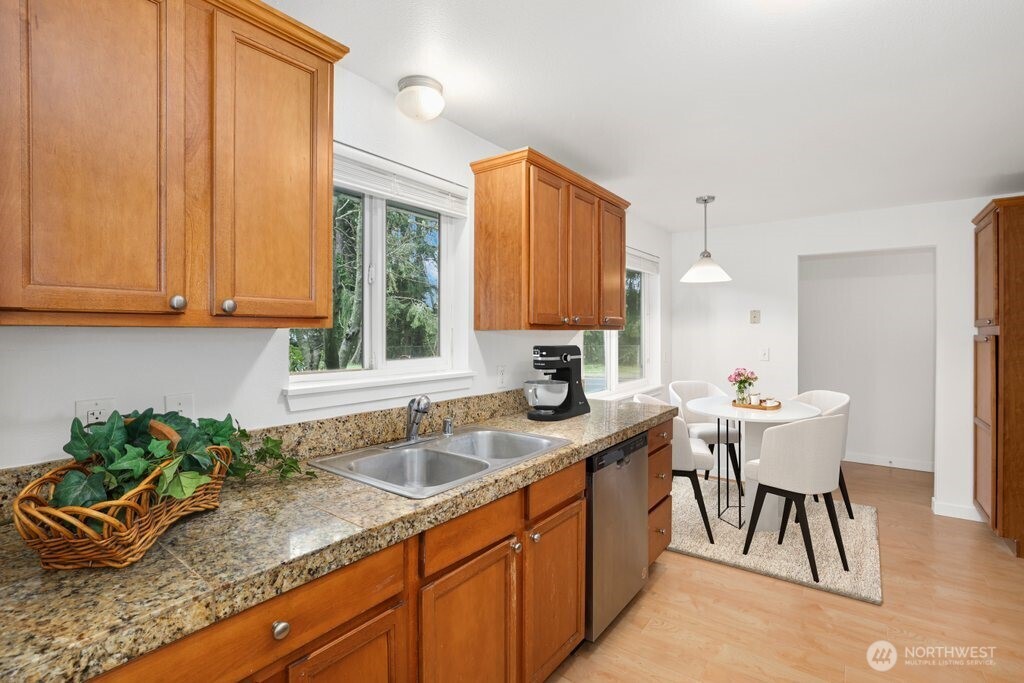 2403 B Street Steilacoom, WA 98388 - Photo 7 of 30 a kitchen with a sink a window and cabinets