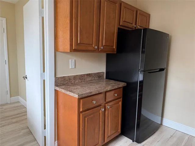 a kitchen with stainless steel appliances granite countertop a refrigerator and a stove