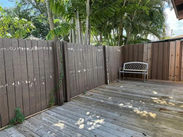 a backyard of a house with barbeque oven and trees