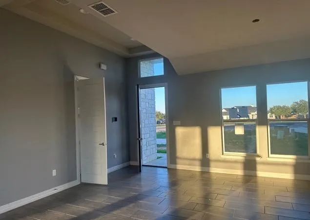 a view of an entryway of a house window and wooden floor