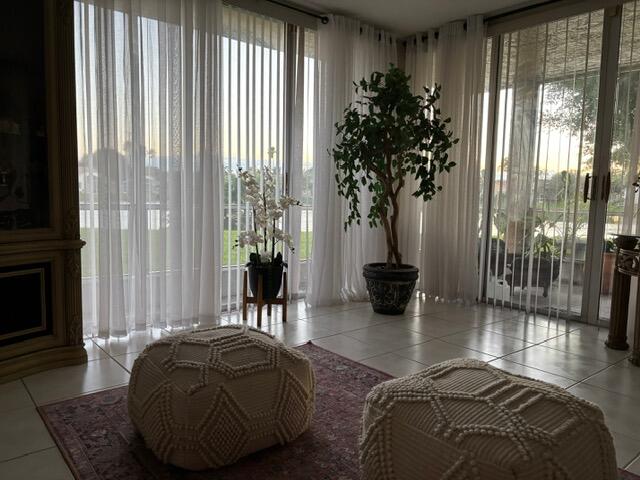 7531 Northwest 86th Terrace, Unit 101 Tamarac, FL 33321 - Photo 14 of 20 a living room with furniture and a potted plant