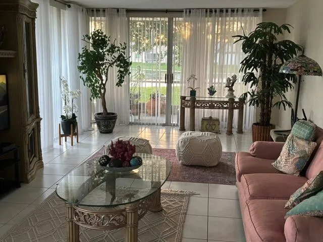 a living room with furniture and a potted plant