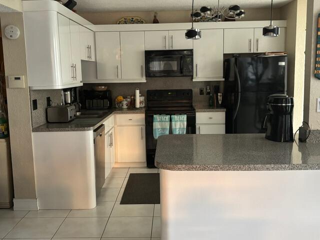 7531 Northwest 86th Terrace, Unit 101 Tamarac, FL 33321 - Photo 17 of 20 a kitchen with stainless steel appliances granite countertop a refrigerator a stove and a sink