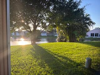 7531 Northwest 86th Terrace, Unit 101 Tamarac, FL 33321 - Photo 18 of 20 a view of yard with swimming pool and outdoor seating