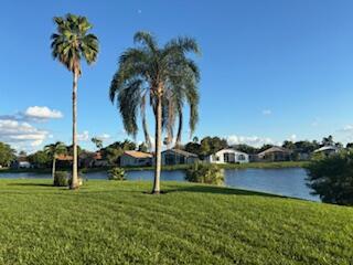 7531 Northwest 86th Terrace, Unit 101 Tamarac, FL 33321 - Photo 20 of 20 a view of a garden with a slide and a lake view