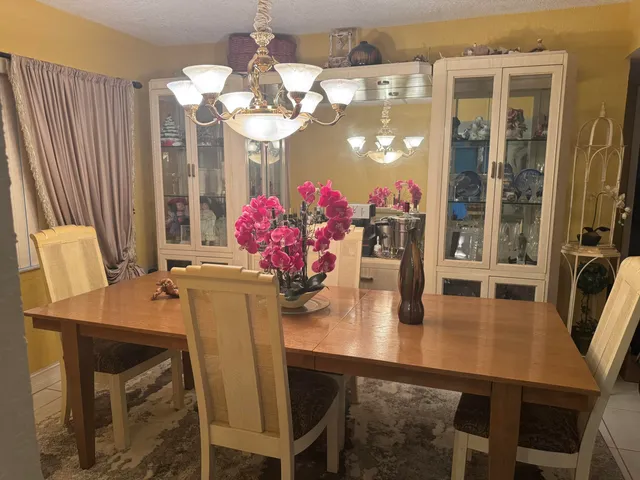 a view of a dining room with furniture and chandelier