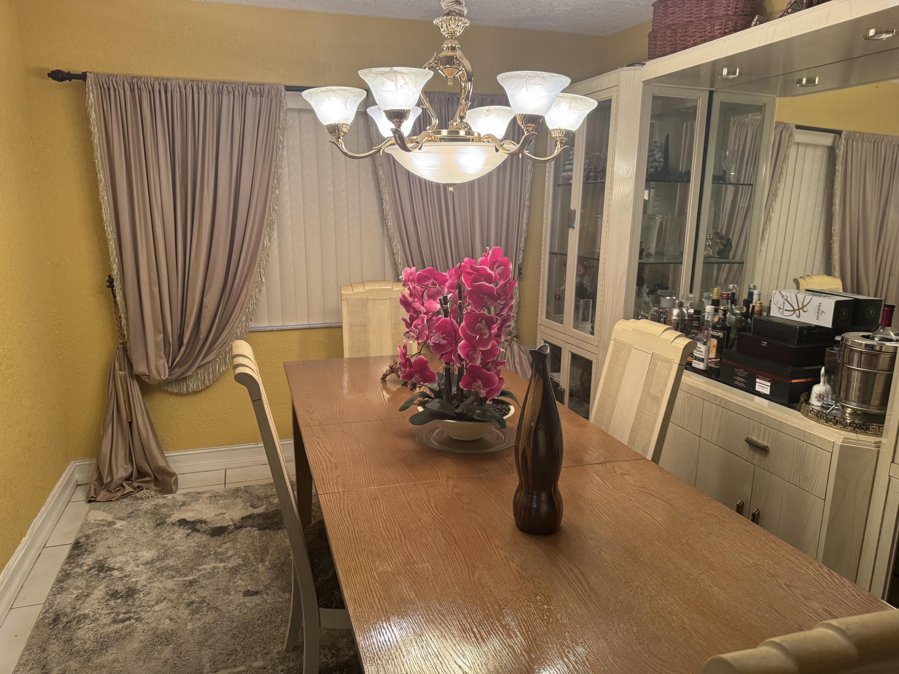 7531 Northwest 86th Terrace, Unit 101 Tamarac, FL 33321 - Photo 8 of 20 a view of a dining room with furniture