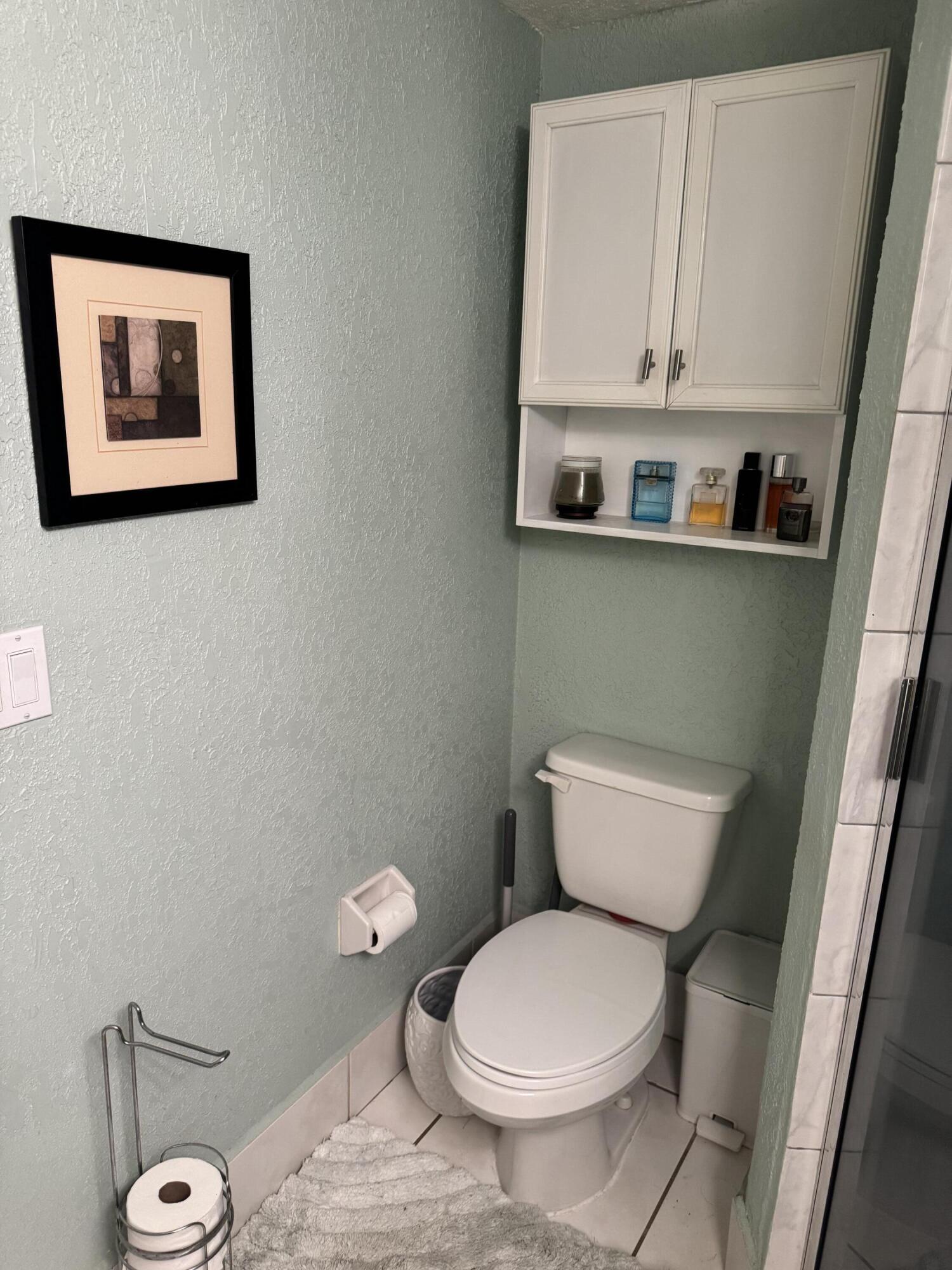 7531 Northwest 86th Terrace, Unit 101 Tamarac, FL 33321 - Photo 10 of 20 a bathroom with a toilet and a sink