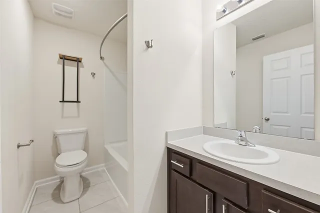 a bathroom with a sink toilet and a mirror