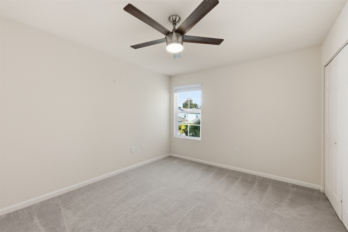 908 Observatory Parkway Jacksonville, FL 32218 - Photo 12 of 16 an empty room with a window and a fan