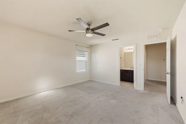 an empty room with closet and windows