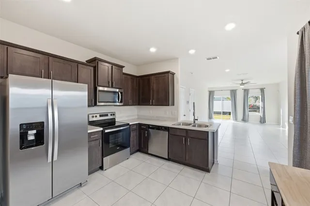 a kitchen with stainless steel appliances granite countertop a sink and cabinets