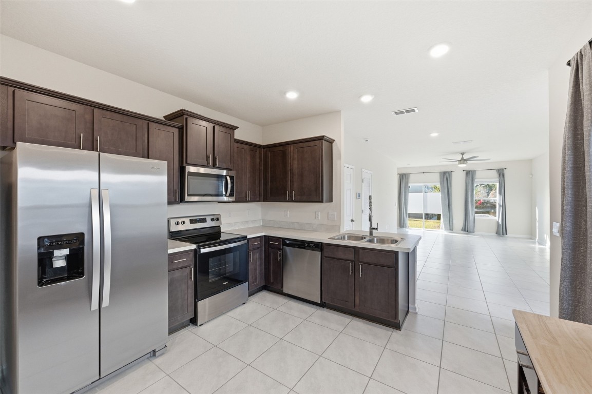 908 Observatory Parkway Jacksonville, FL 32218 - Photo 5 of 16 a kitchen with stainless steel appliances granite countertop a sink and cabinets
