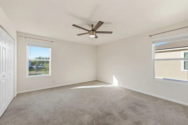 a view of a livingroom with a ceiling fan and window