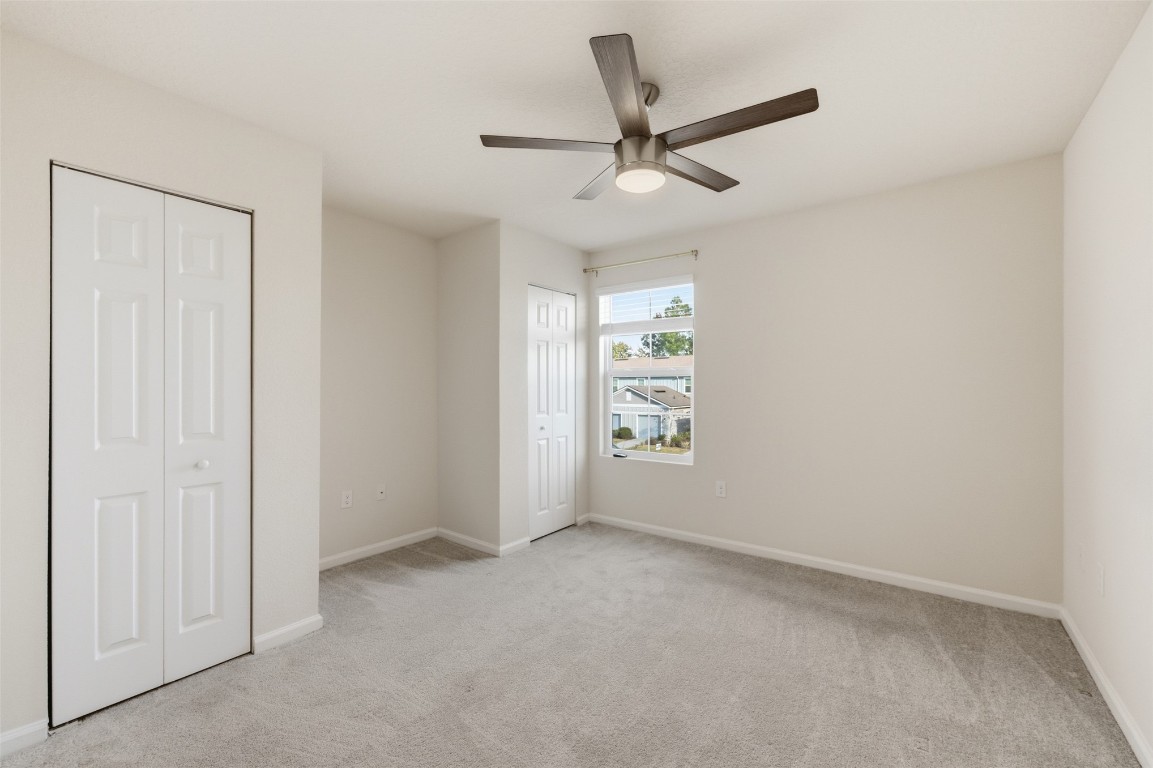 908 Observatory Parkway Jacksonville, FL 32218 - Photo 10 of 16 an empty room with windows and fan