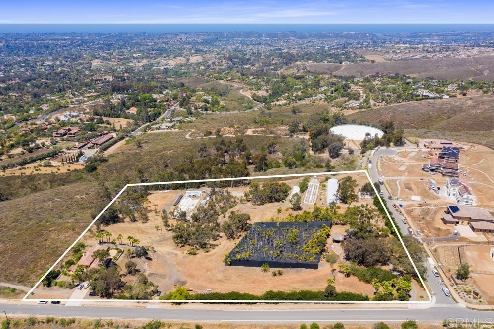 an aerial view of a residential houses with outdoor space