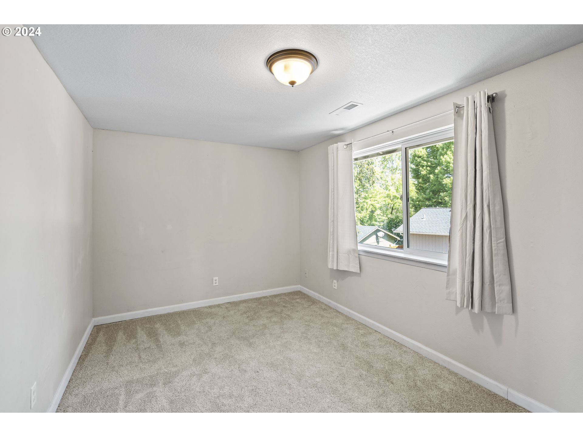 163 Christa Lane Eagle Point, OR 97524 - Photo 18 of 24 a view of an empty room with wooden floor and windows