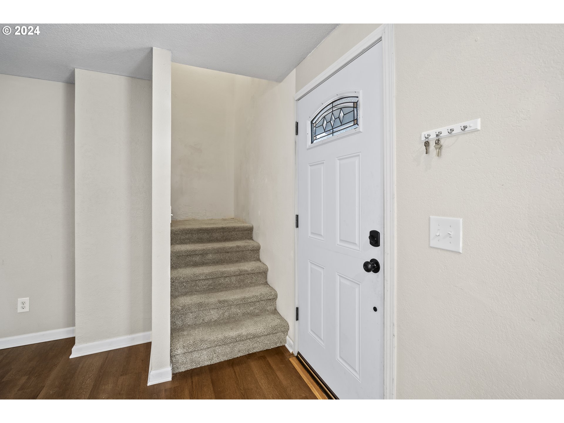 163 Christa Lane Eagle Point, OR 97524 - Photo 4 of 24 a view of a hallway with wooden floor and staircase