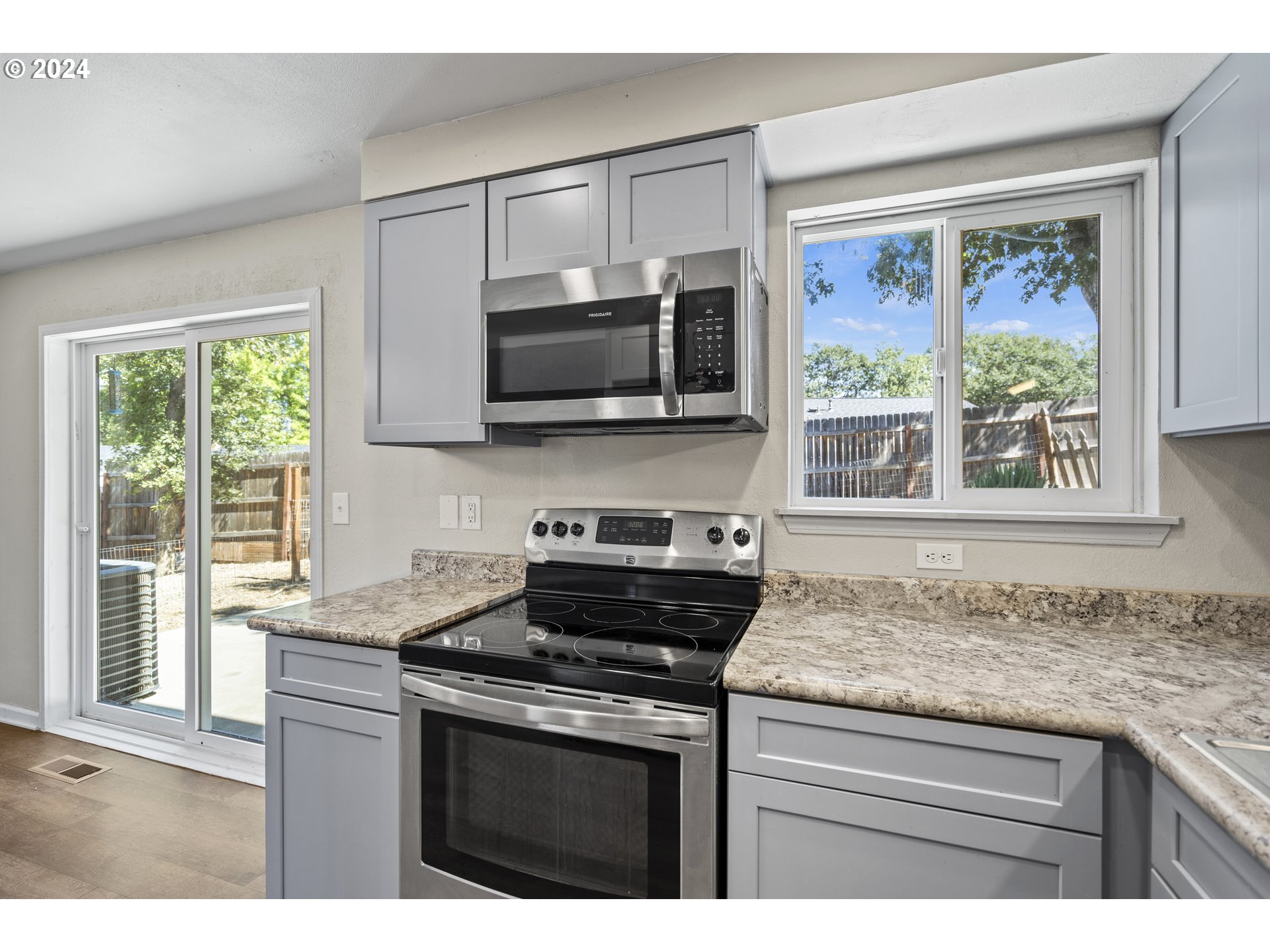 163 Christa Lane Eagle Point, OR 97524 - Photo 9 of 24 a kitchen with granite countertop a stove sink and microwave