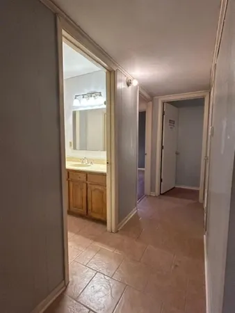 a view of a hallway with a bathroom