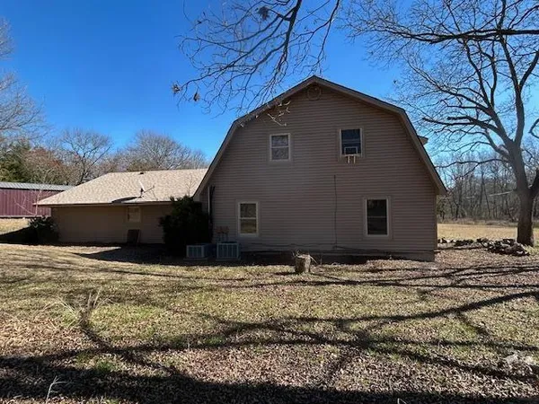 a backyard of a house with large trees