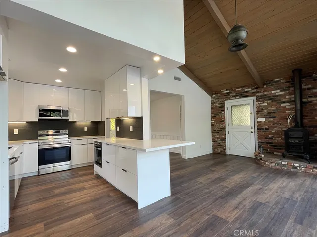 a kitchen with a sink and stainless steel appliances