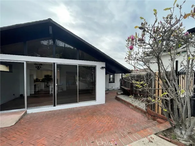 a view of a balcony with chairs and wooden floor