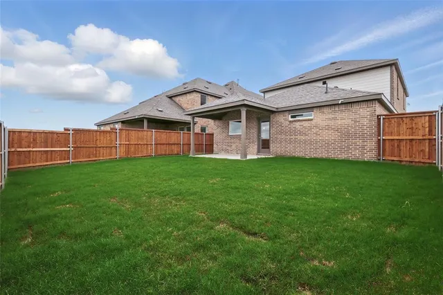 a front view of a house with a garden and yard