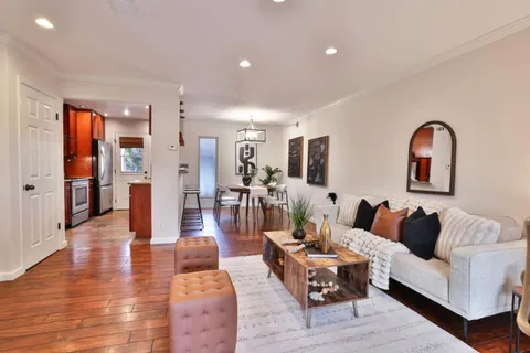 a living room with furniture and wooden floor