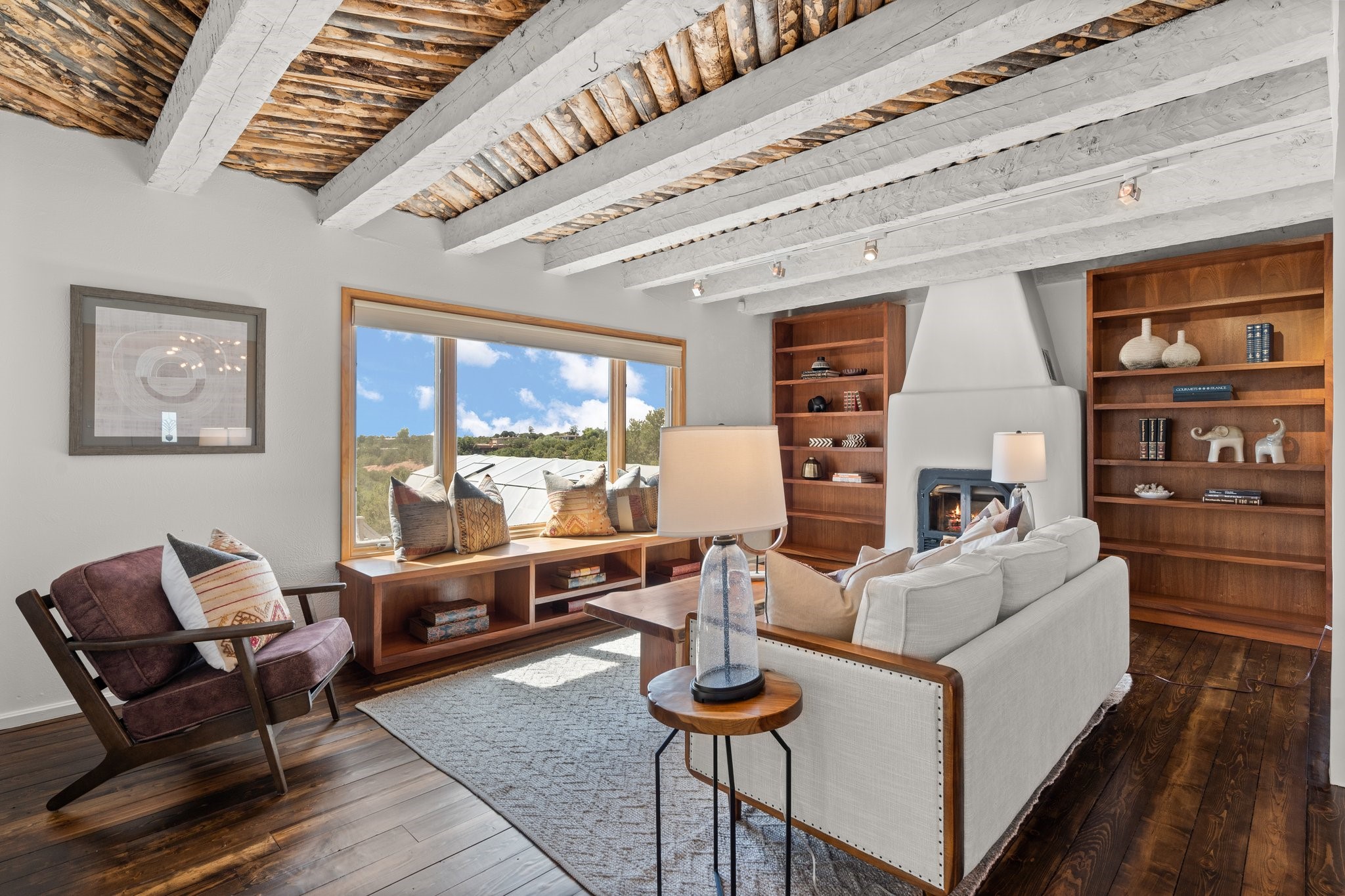 View of the light filled living room, Note the beautiful ceiling treatment