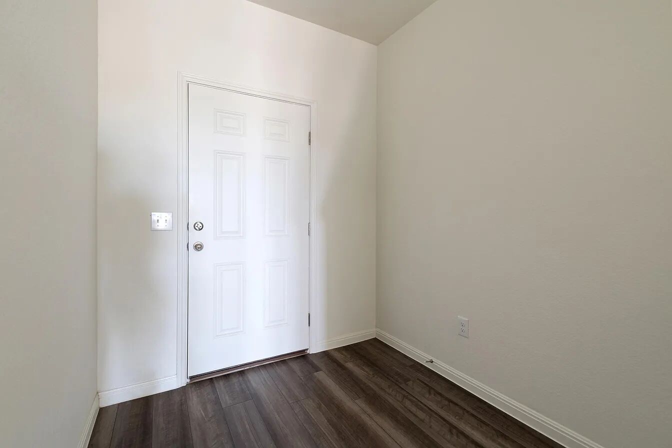 101 Aoudad Road Hutto, TX 78634 - Photo 7 of 39 A classic six-panel entry door greets you, complemented by rich wood flooring.