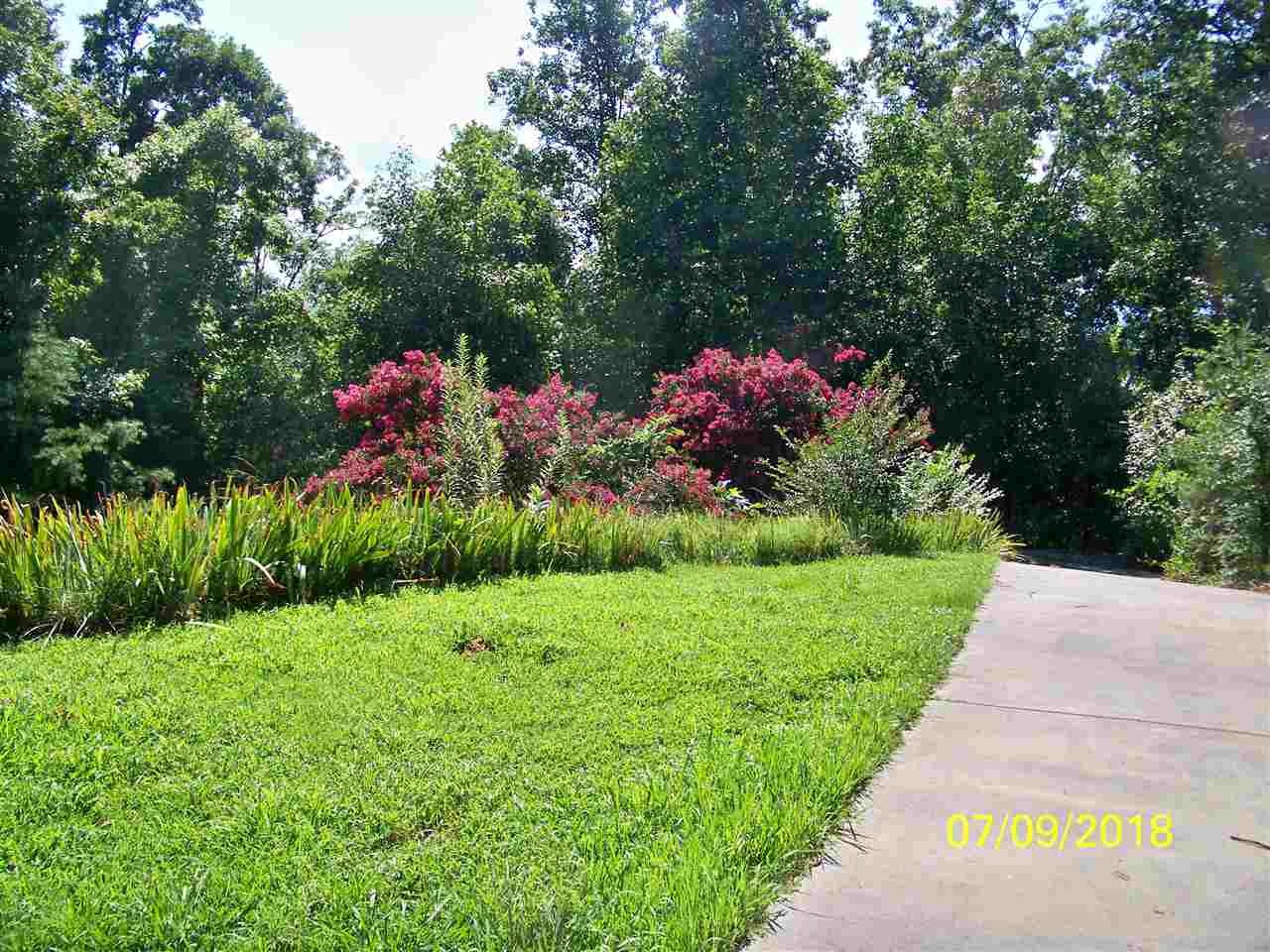 2683 Highway 30 Decatur, TN 37322 - Photo 11 of 47 a front view of a house with a yard and garage