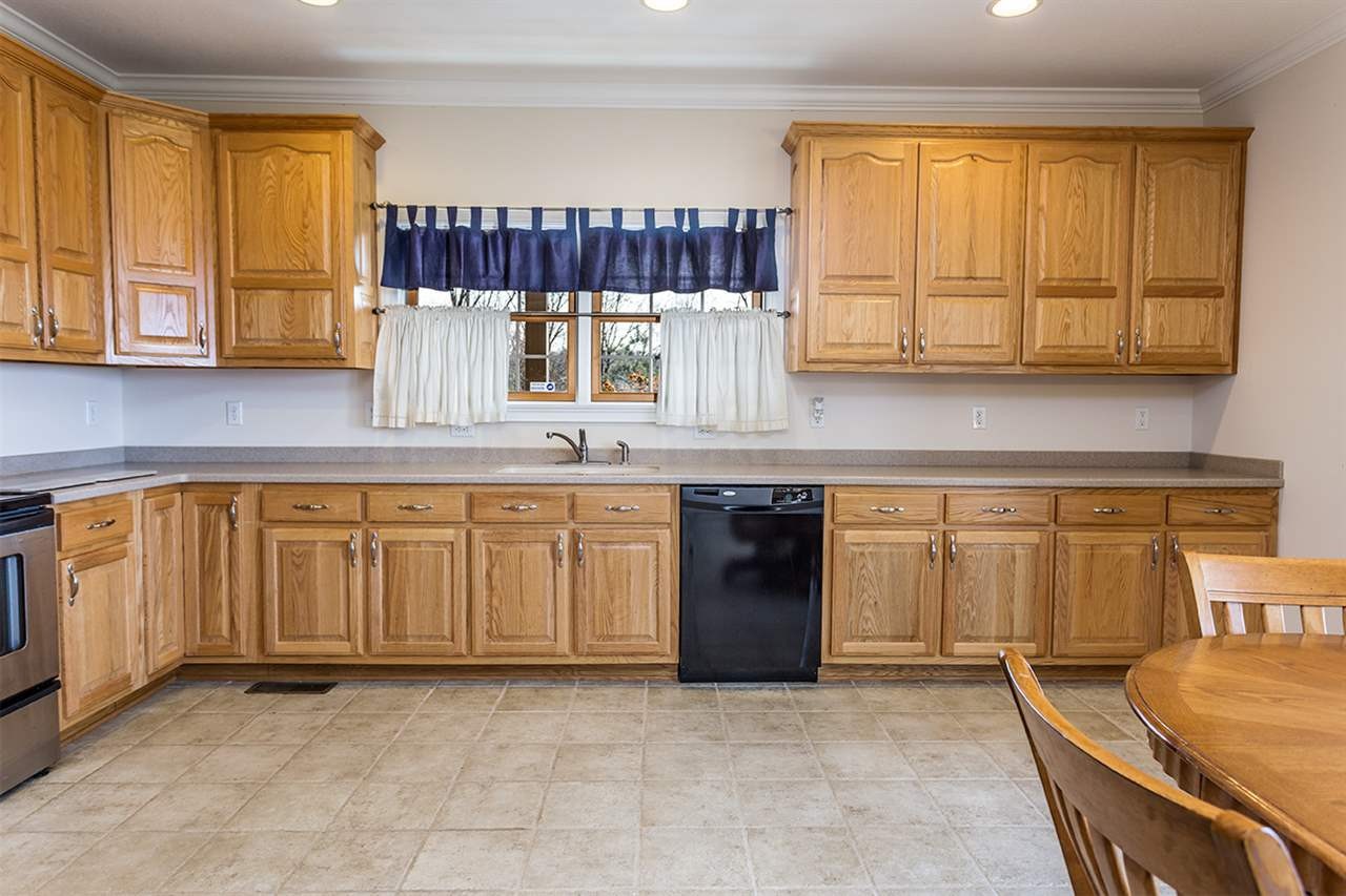 2683 Highway 30 Decatur, TN 37322 - Photo 18 of 47 a kitchen with granite countertop a sink a stove and cabinets