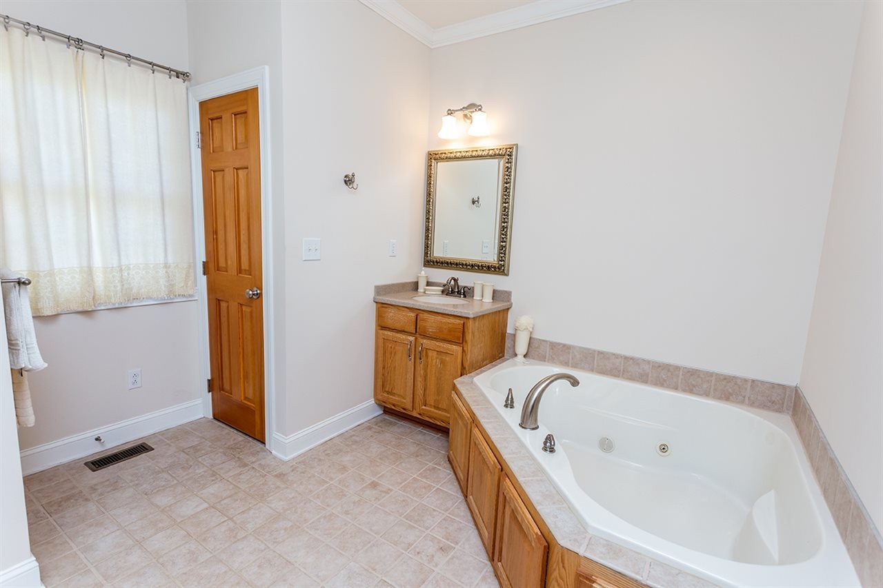 2683 Highway 30 Decatur, TN 37322 - Photo 29 of 47 a bathroom with a tub sink and mirror
