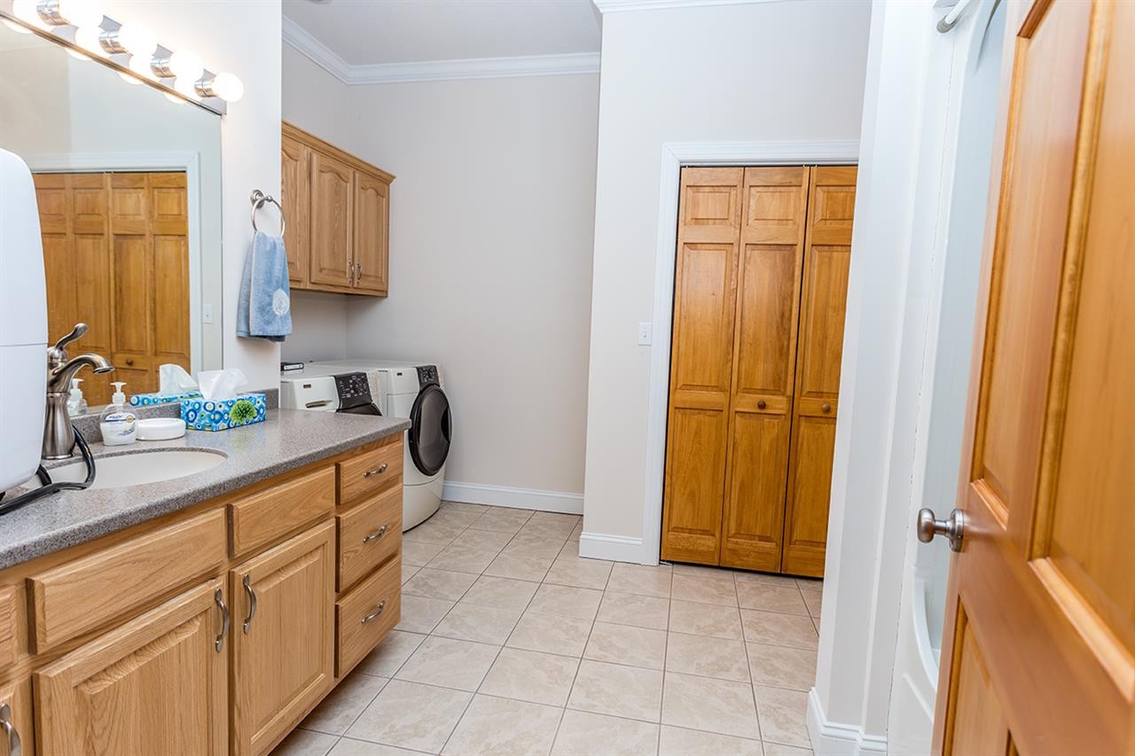 2683 Highway 30 Decatur, TN 37322 - Photo 45 of 47 a bathroom with a granite countertop sink a mirror and a bathtub