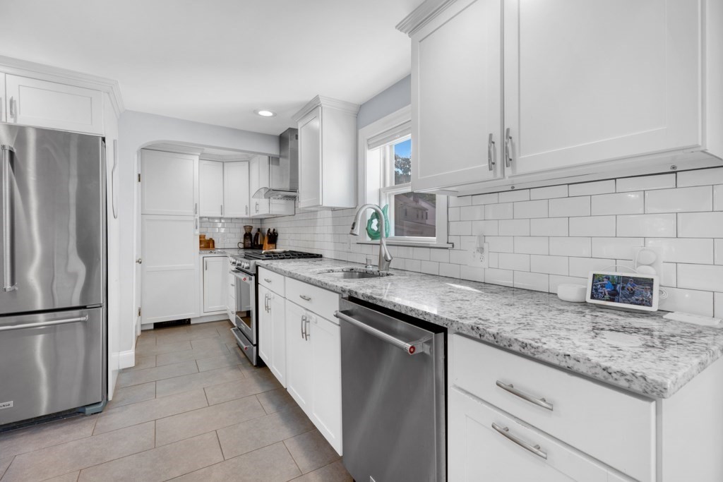 4 Rice Road Quincy, MA 02170 - Photo 11 of 26 a kitchen with stainless steel appliances granite countertop a sink stove and refrigerator