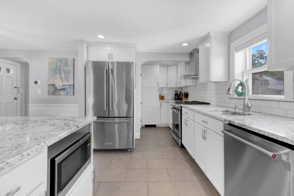 4 Rice Road Quincy, MA 02170 - Photo 12 of 26 a kitchen with stainless steel appliances granite countertop a sink stove and refrigerator