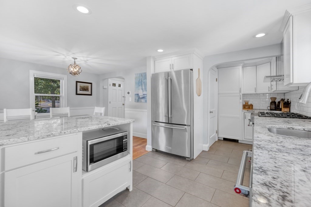 4 Rice Road Quincy, MA 02170 - Photo 13 of 26 a kitchen with granite countertop a refrigerator sink stove and cabinets