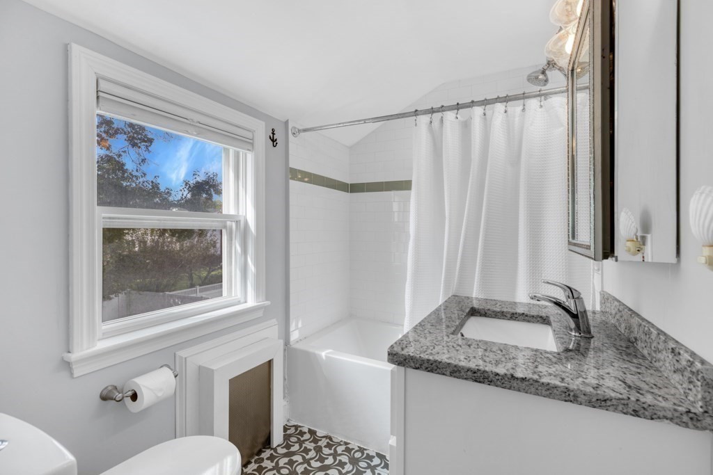 4 Rice Road Quincy, MA 02170 - Photo 21 of 26 a bathroom with a granite countertop sink a mirror a vanity and a shower