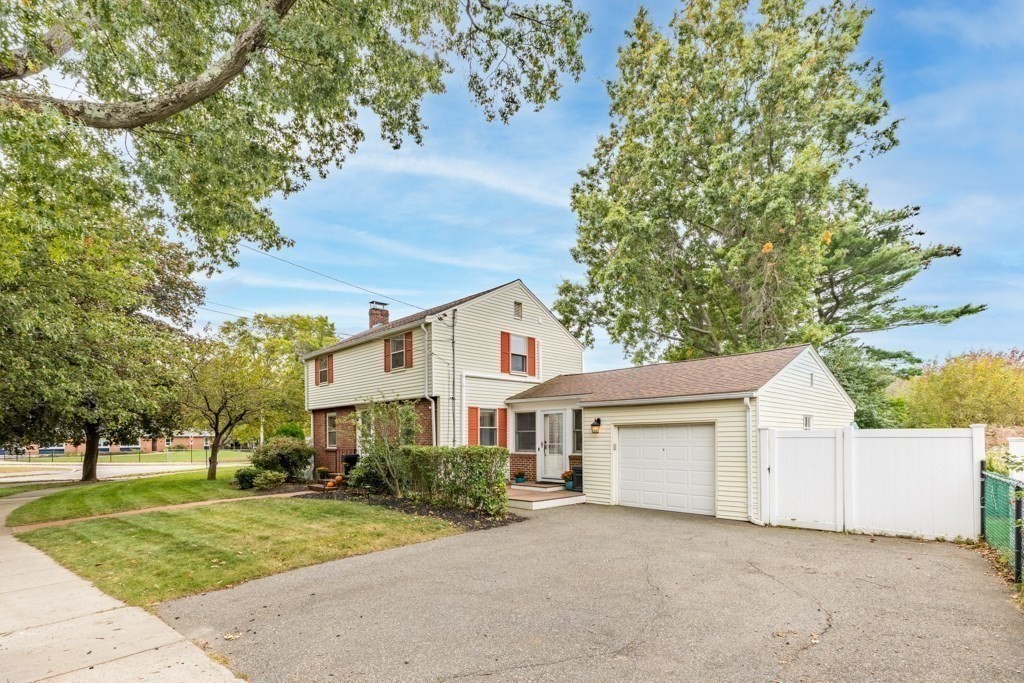 4 Rice Road Quincy, MA 02170 - Photo 3 of 26 a front view of a house with a garden and trees