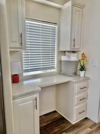 a kitchen with stainless steel appliances cabinets and window