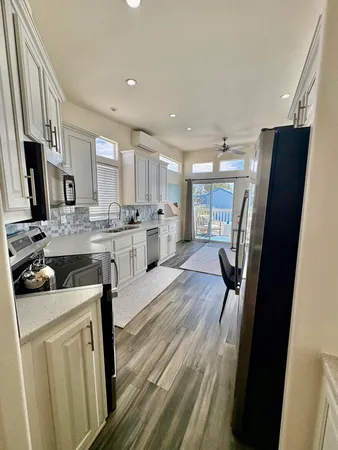 a kitchen with stainless steel appliances granite countertop a refrigerator stove microwave and sink