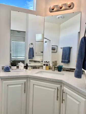 a bathroom with a double vanity sink and a mirror