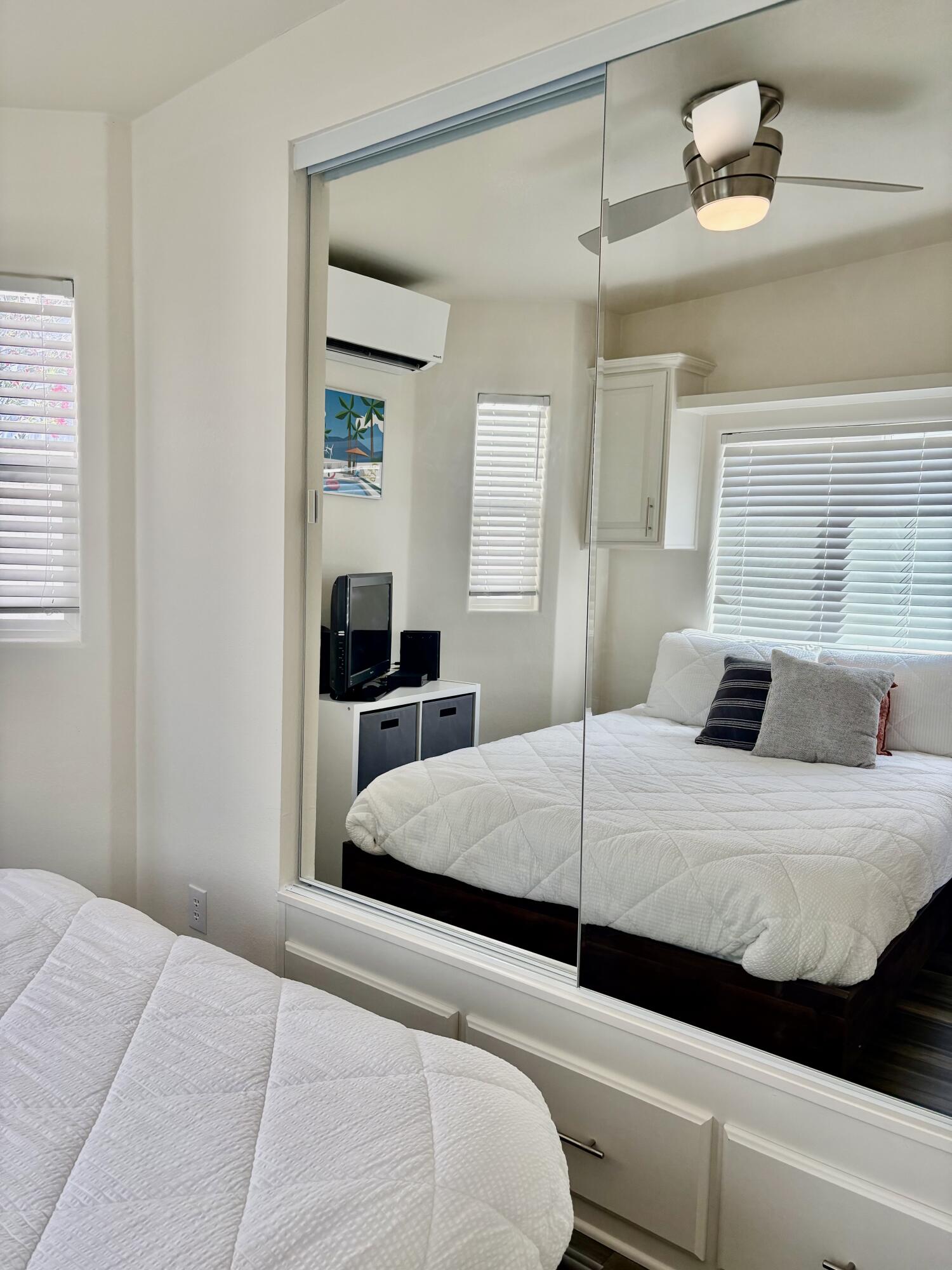 70200 Dillon Road, Unit 200 Desert Hot Springs, CA 92241 - Photo 20 of 31 a bedroom with a bed and a large mirror