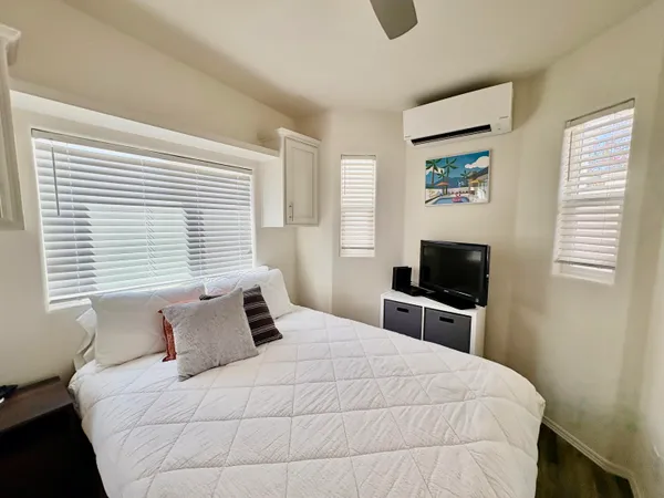 a bedroom with a bed and a television