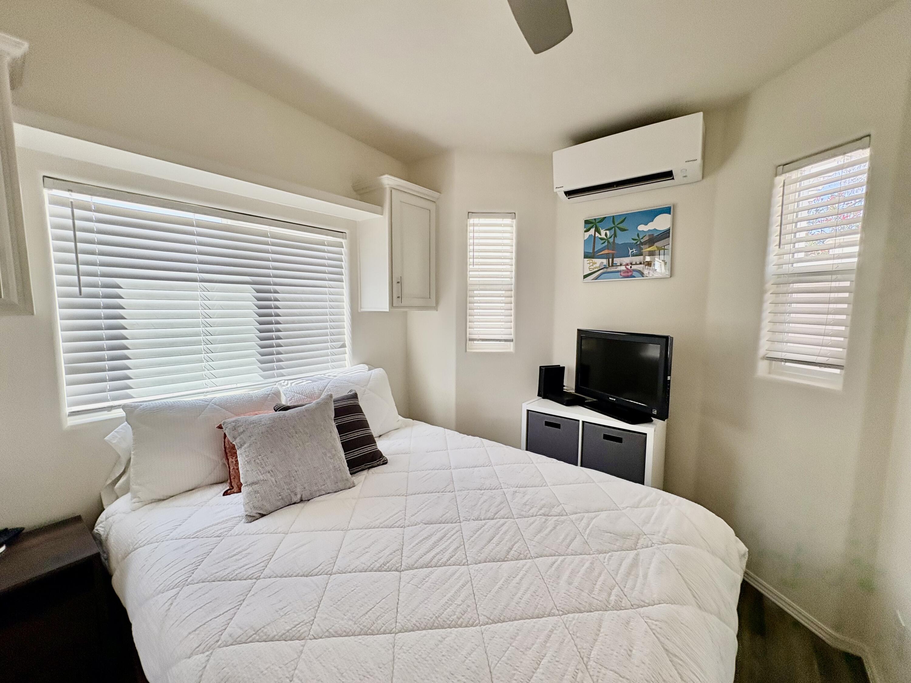 70200 Dillon Road, Unit 200 Desert Hot Springs, CA 92241 - Photo 22 of 31 a bedroom with a bed and a television